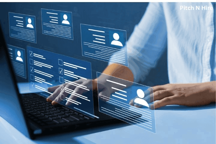Recruiter using a laptop with digital resume profiles and checklists, representing AI-powered applicant tracking and resume screening system.
